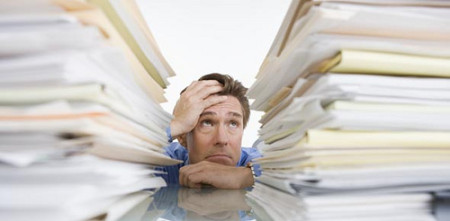 Businessman Overwhelmed with Paperwork